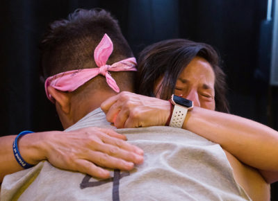 A youth leader hugging a teen.