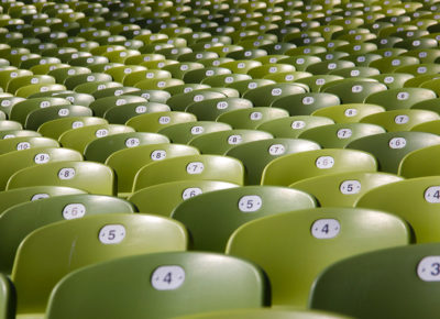 A group of numbered chairs in an auditorium.